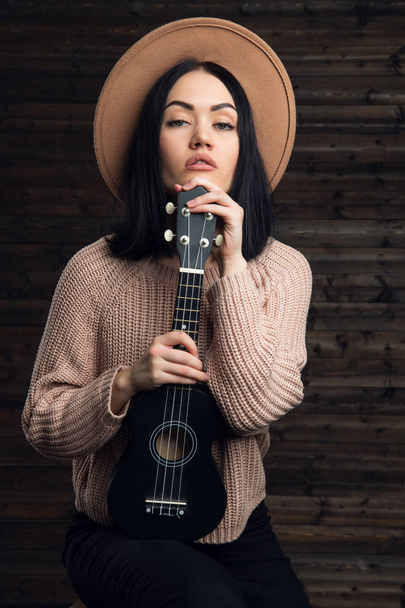 Country music girl portrait indoors on wooden background - Photo, Image
