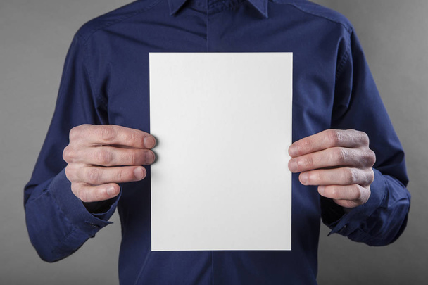 A man holding white booklet - 写真・画像