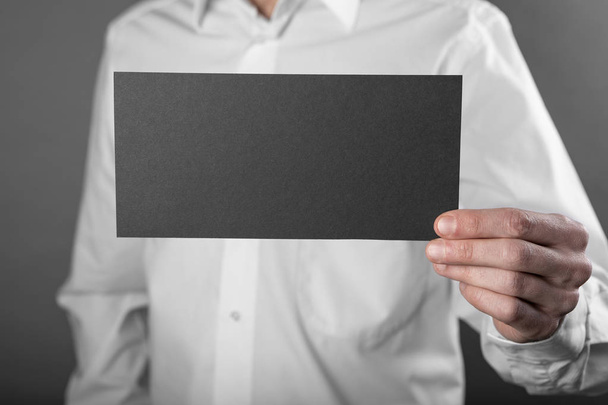 A man holding black booklet - Фото, зображення