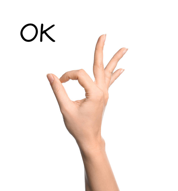 Woman showing word Okay on white background, closeup. Sign language - Фото, зображення