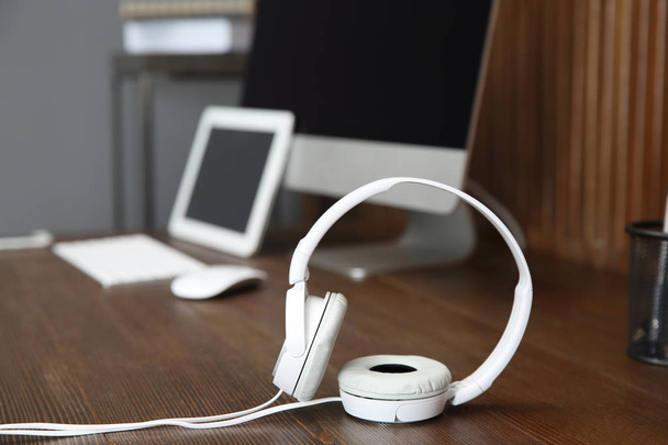 Stylish headphones on office table. Space for text - Fotó, kép