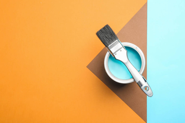 Paint can and brush on color background, top view. Space for text - Photo, image