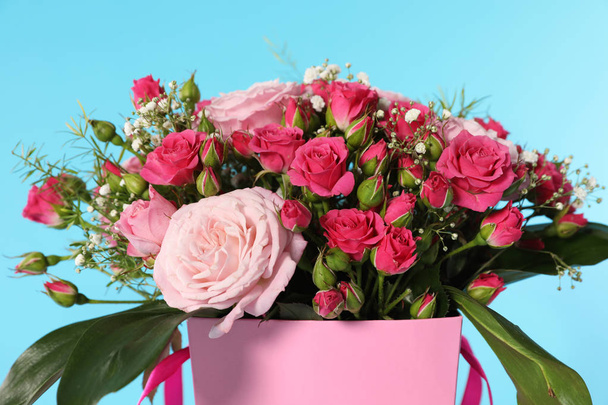 Beautiful bouquet of flowers in paper gift box on color background - Zdjęcie, obraz