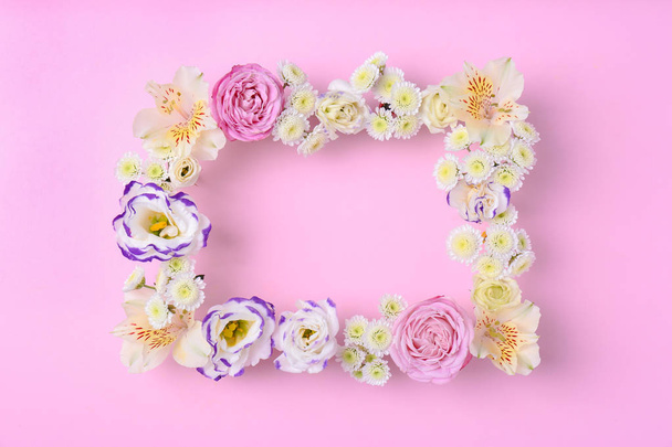 Frame of fresh flowers on wooden background, top view. Space for text - Photo, Image