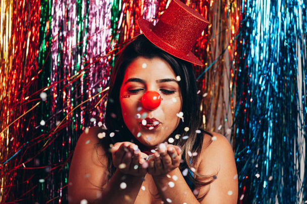 A female clown with colorful clothes and makeup on colorful background - Fotó, kép