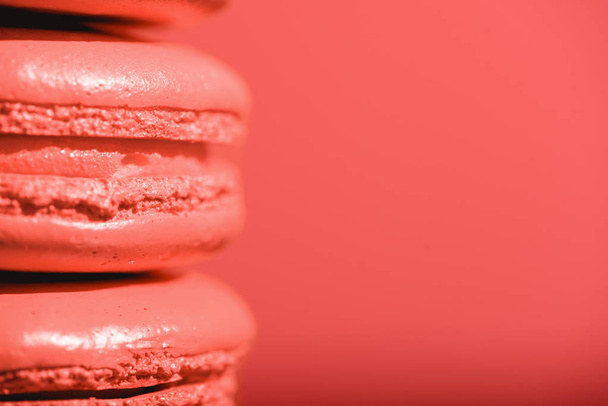 close up of Living coral macaroons on red background. Pantone color of the year 2019 concept - Valokuva, kuva