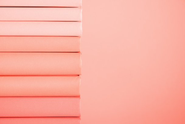 stack of books on living coral background. Pantone color of the year 2019 concept - Fotoğraf, Görsel