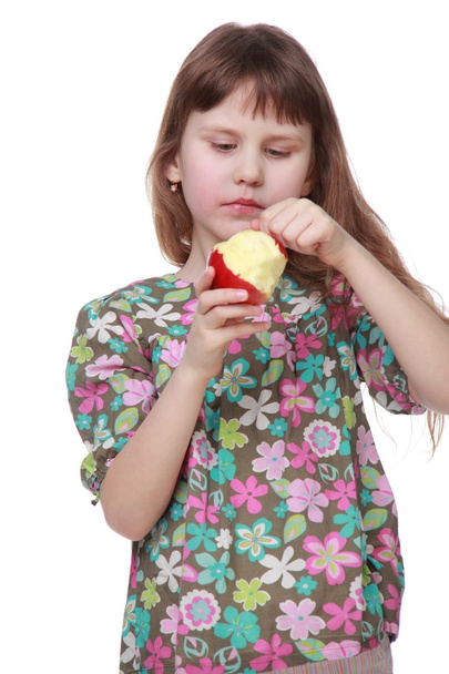 Beautiful little girl eating an apple - Zdjęcie, obraz
