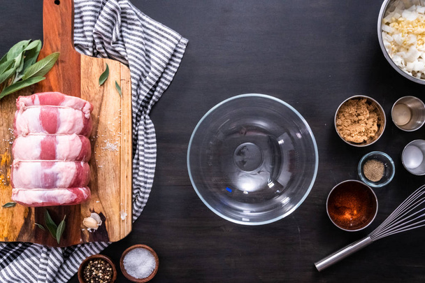 Flat lay. Undercooked boneless pork roast on the cutting board. - Foto, Imagem