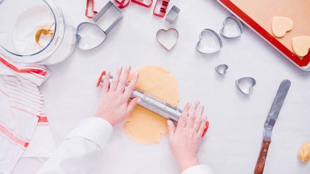 Flat lay. Step by step. Rolling sugar cookie dough with metal rolling pin. - Zdjęcie, obraz