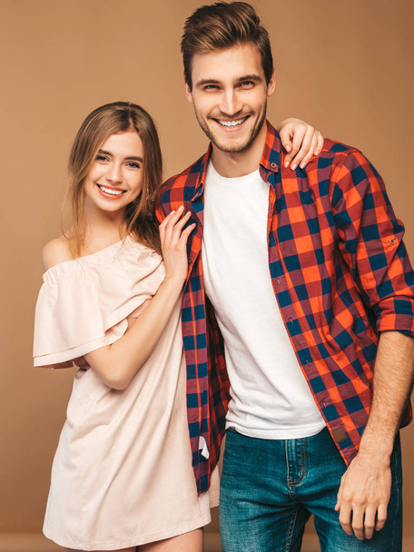 Portrait of Smiling Beautiful Girl and her Handsome Boyfriend laughing.Happy Cheerful Family. in sunglasses.Valentine's Day. Posing on beige wall. Hugging - Foto, Imagen