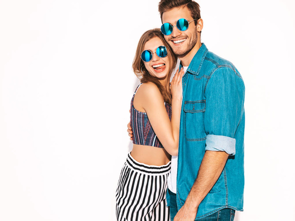Portrait of Smiling Beautiful Girl and her Handsome Boyfriend laughing.Happy Cheerful Family in round sunglasses.Valentine's Day. Isolated on white. Hugging - Φωτογραφία, εικόνα