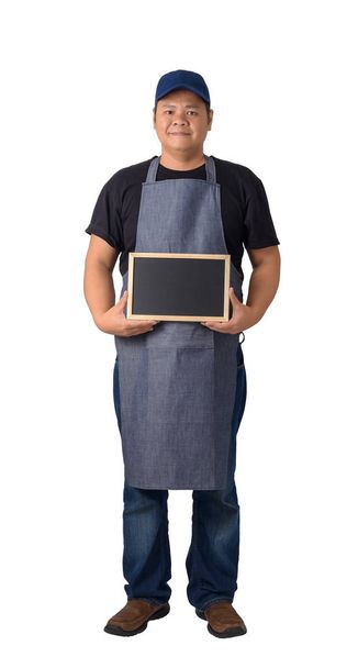 Full Body worker man or Serviceman in Black shirt and apron is holding chalkboard isolated on white background with clipping path - Photo, Image