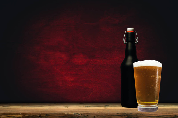 Glass of beer on a old oak table and background - Photo, Image