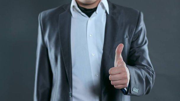 closeup.young business men showing thumb up. photo with copy space - Foto, Bild
