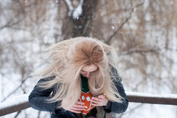 雪に覆われた冬の公園の背景をぼかした写真に美しい表現力豊かな少女 - 写真・画像