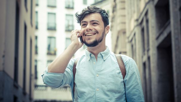 stylish man in the street at the phone - 写真・画像