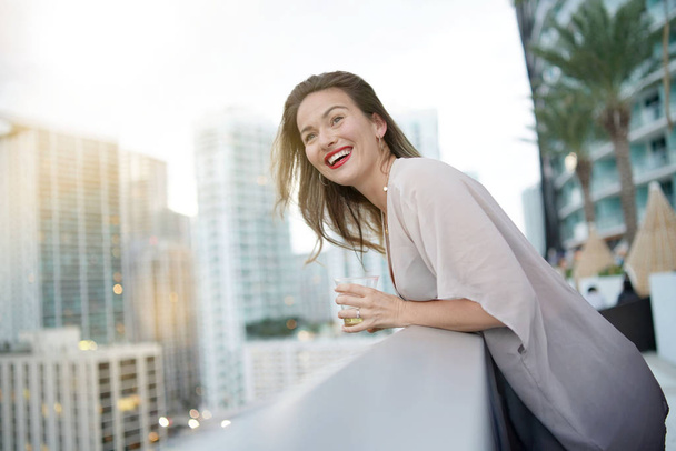 Atttractive elegant young woman having fun smiling on rooftop bar in city - Fotografie, Obrázek