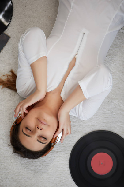 the image of resting sexy woman listening to vinyl - Photo, Image