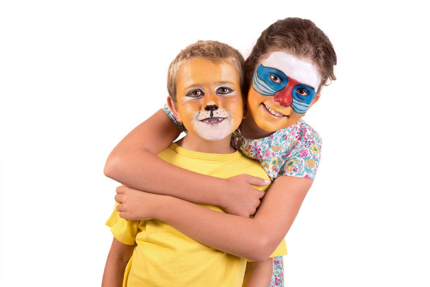 Children's couple with animal face-paint isolated in white - Foto, imagen