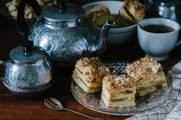Traditional Russian homemade cake Napoleon, puff pastry custard cream pie on wooden table, rustic style - Foto, Bild
