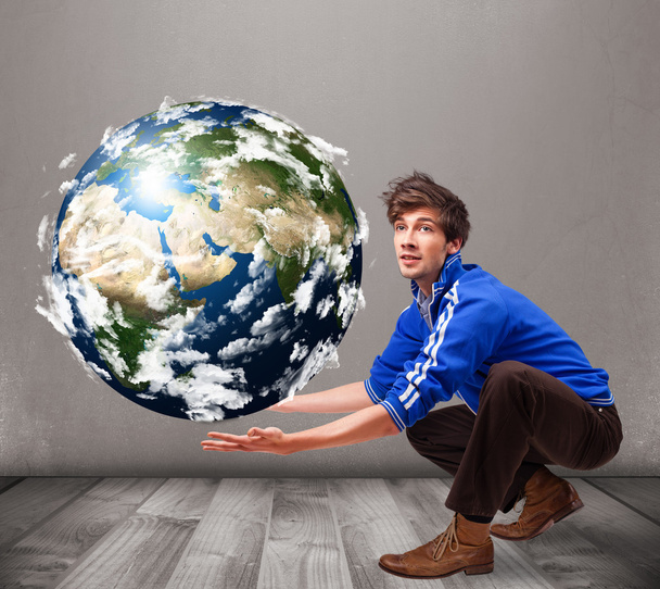Good-looking man holding 3d planet earth - Foto, Imagem