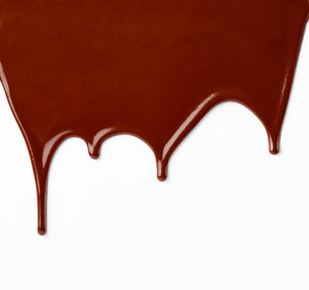 Close up van chocolade siroop op witte achtergrond - Foto, afbeelding
