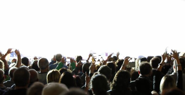 many people with smartphone during a live concert and customizable white background - Photo, Image