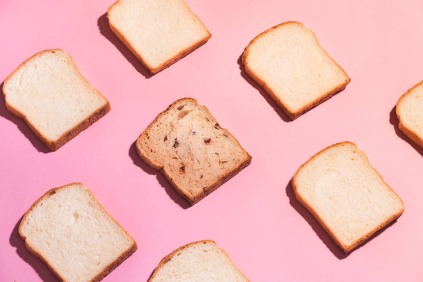 Sliced bread to toast isolated on pink background. Close up. Top view - Фото, зображення