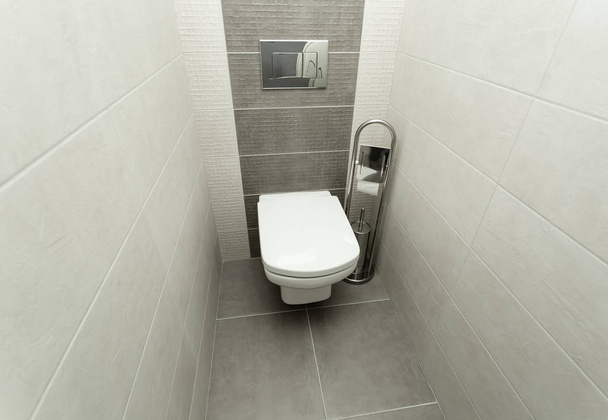 White toilet bowl in modern bathroom with paper holder and toilet brush. - Foto, Imagem