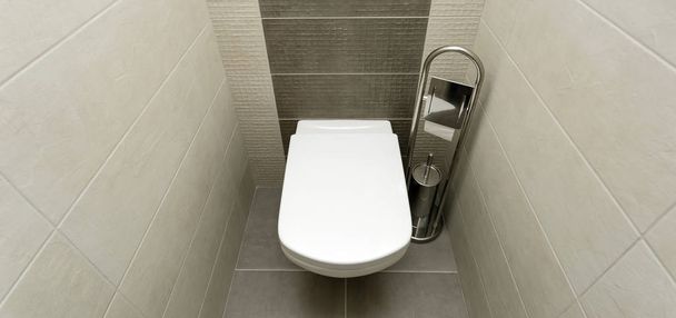 White toilet bowl in modern bathroom with paper holder and toilet brush. - Zdjęcie, obraz