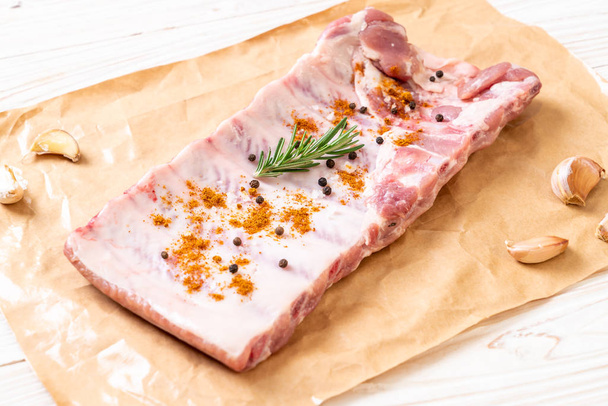 Fresh raw pork ribs ready for roasting with ingredients - Фото, зображення