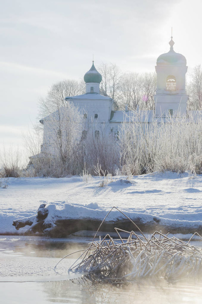 Orthodox church near by river. Pskov. Mirozhsky Monastery. Winter. Frozen river - Fotó, kép