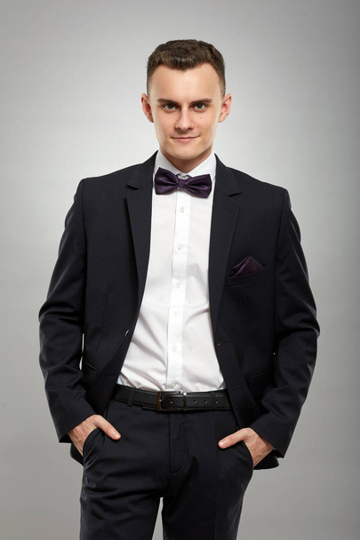 Closeup of a young man in a business suit - Photo, image