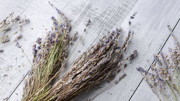 dry natural lavender flowers over wooden background - Photo, image