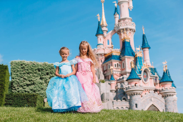 Little adorable girls in beautiful princess dress at fairy-tale park - Φωτογραφία, εικόνα