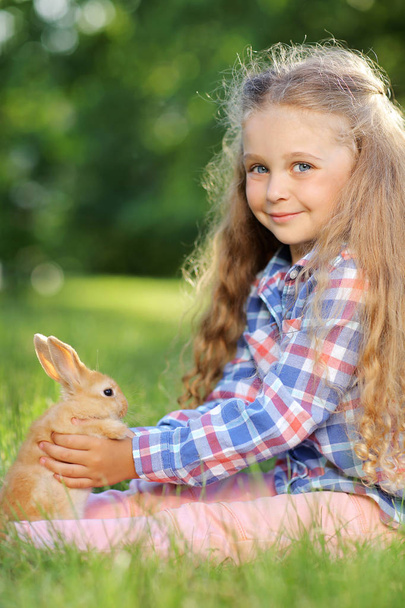 cute girl with little bunny in summer park - Foto, imagen