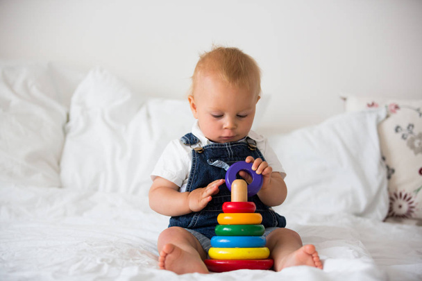 Sweet baby boy, toddler child, playing at home with colorful ring toy - Foto, immagini