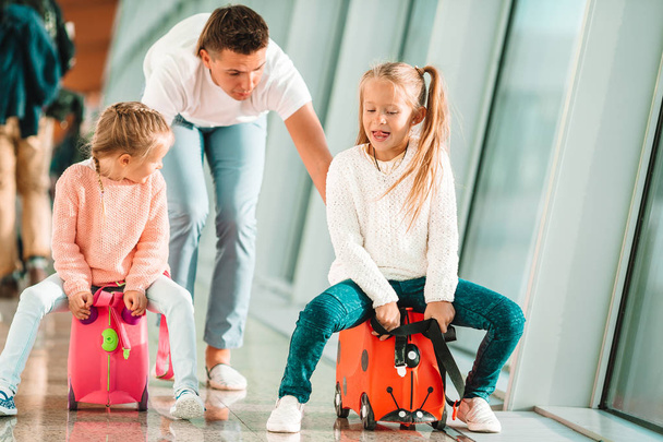 Happy family with two kids in airport have fun waiting for boarding - Foto, Imagen