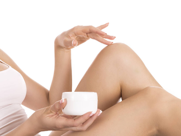 Woman applying body lotion on leg. Skin care concept. - Photo, Image