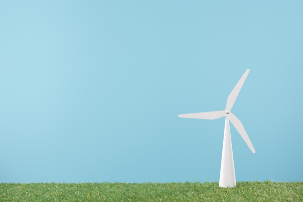 windmill model on green grass and blue background    - Φωτογραφία, εικόνα