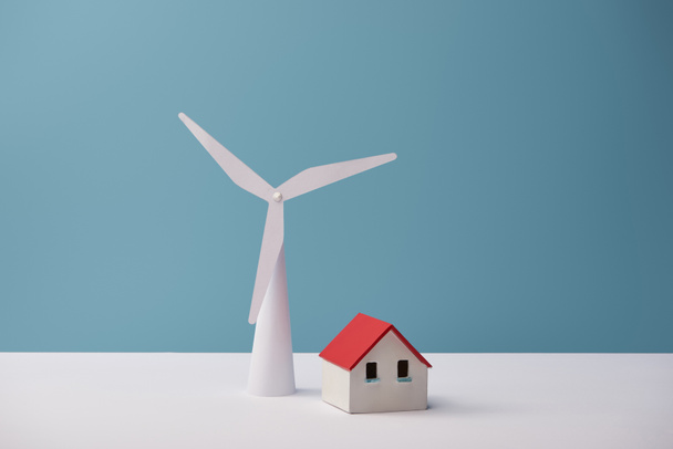 windmill and house models on white table and blue background - Photo, Image
