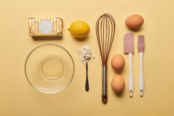 top view of kitchenware and ingredients on yellow  background - Foto, Bild