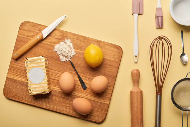 top view of cooking utensils and ingredients on yellow background  - 写真・画像