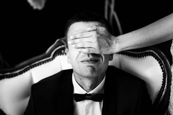 cool bride hands over the eyes of the groom - 写真・画像