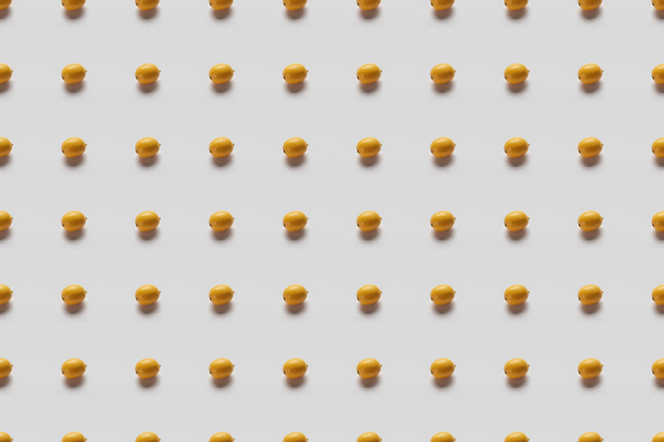 top view of yellow bright lemons on grey background, seamless pattern - Foto, afbeelding