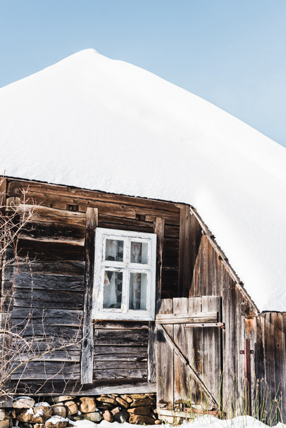 old wooden house covered with snow in winter - 写真・画像