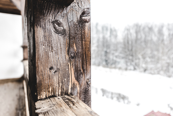 selective focus of textured wooden plank on snowy background - Foto, imagen