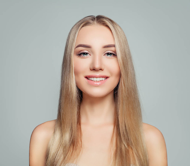 Young perfect woman with blonde hair and healthy skin. Girl smiling. Facial treatment, haircare and cosmetology concept - Photo, Image