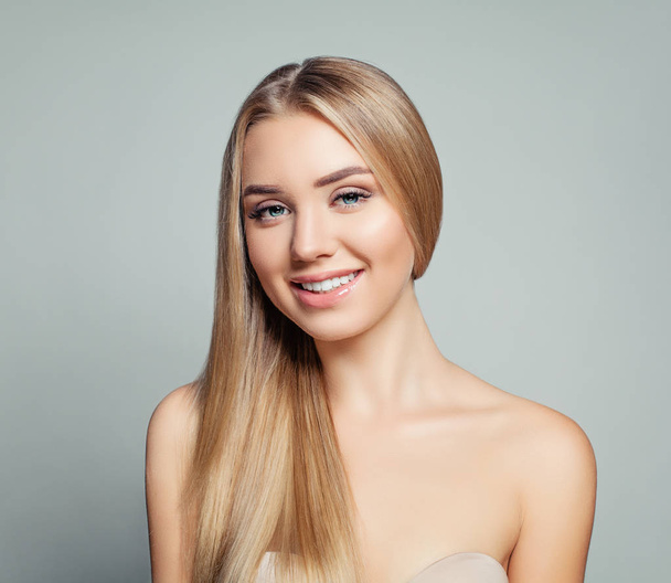 schöne blonde Frau mit langen gesunden Haaren und klarer Haut. Gesichtsbehandlung, Haarpflege und Kosmetologie - Foto, Bild